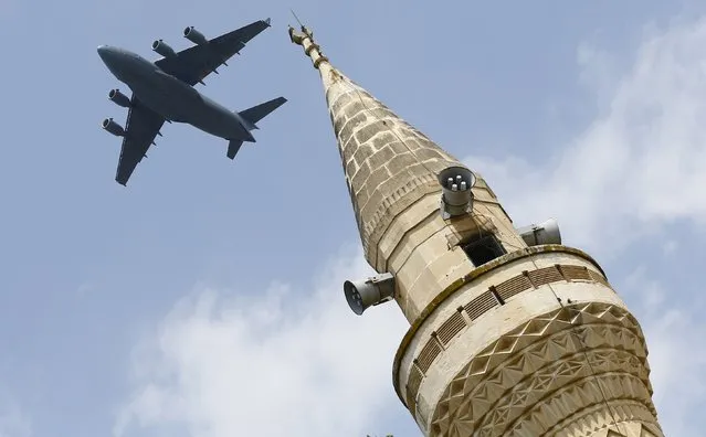 A U.S. Air Force Boeing C-17A Globemaster III large transport aircraft flies over a minaret after taking off from Incirlik air base in Adana, Turkey, in this August 12, 2015 file photo. (Photo by Murad Sezer/Reuters)