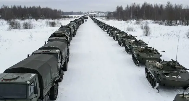 This handout image grab taken on January 6, 2022 and released on January 7, 2022 by the Russian Defence Ministry, shows an aerial view of Russian military vehicles waiting for loading to a military cargo plane to depart to Kazakhstan at the airport of Ivanovo. - A Moscow-led military alliance dispatched troops to help quell mounting unrest in Kazakhstan as police said dozens were killed trying to storm government buildings. Long seen as one the most stable of the ex-Soviet republics of Central Asia, energy-rich Kazakhstan is facing its biggest crisis in decades after days of protests over rising fuel prices escalated into widespread unrest. (Photo by Russian Defence Ministry/Handout via AFP Photo)