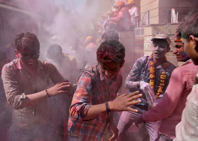 People throw coloured powder during Holi celebrations in the town of Barsana in the state of Uttar Pradesh, India, March 6, 2017. (Photo by Cathal McNaughton/Reuters)