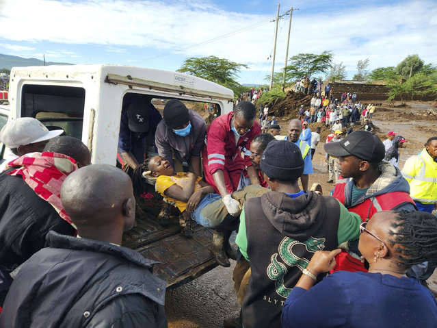 Paramedics carry an injured woman after a dam burst, in Kamuchiri Village Mai Mahiu, Nakuru County, Kenya, Monday, April. 29, 2024. Police in Kenya say at least 40 people have died after a dam collapsed in the country's west. (Photo by AP Photo)
