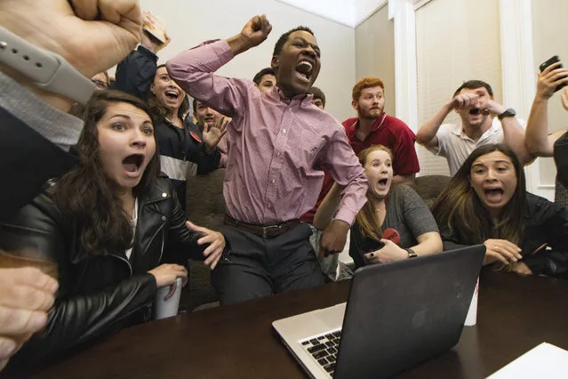 Jared Hunter, center, and his campaign staff react to his election as student body president at the University of Alabama in Tuscaloosa, Ala., on Tuesday, March 7, 2017. Originally from Wetumpka, Ala., Hunter is the first black student to win the position with the backing of a secretive group called The Machine, which is composed of the school's most prestigious, historically white fraternities and sororities. (Photo by Jacob Arthur/Alabama Crimson White via AP Photo)