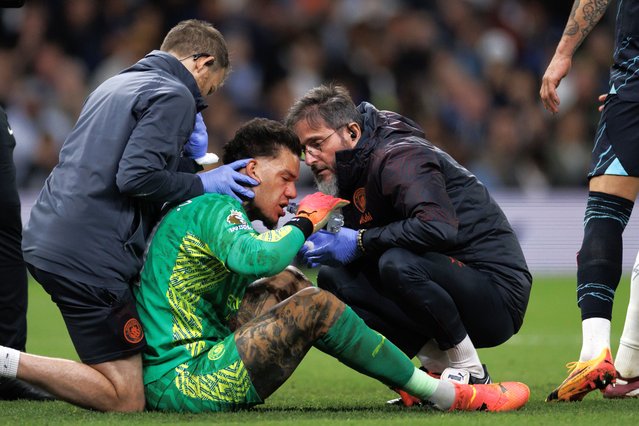 Ederson of Manchester City is checked by medics before having to leave the game through injury during the Premier League match between Tottenham Hotspur and Manchester City at Tottenham Hotspur Stadium on May 14, 2024 in London, England. (Photo by Marc Atkins/Getty Images)