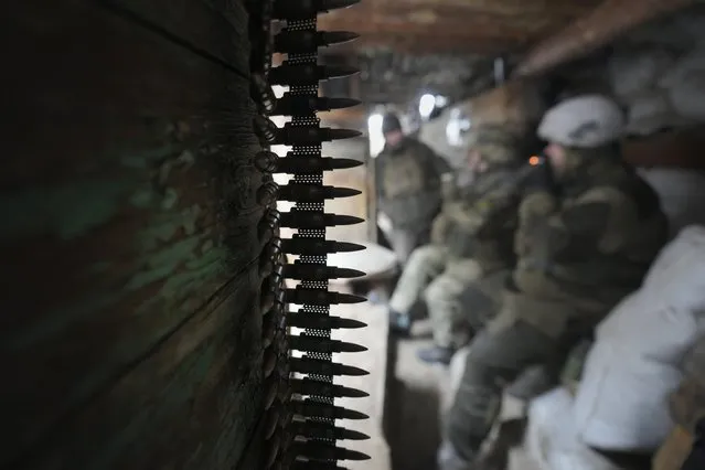 Ukrainian servicemen rest in a shelter on the front line in the Luhansk region, eastern Ukraine, Friday, January 28, 2022. High-stakes diplomacy continued on Friday in a bid to avert a war in Eastern Europe. The urgent efforts come as 100,000 Russian troops are massed near Ukraine's border and the Biden administration worries that Russian President Vladimir Putin will mount some sort of invasion within weeks. (Photo by Vadim Ghirda/AP Photo)