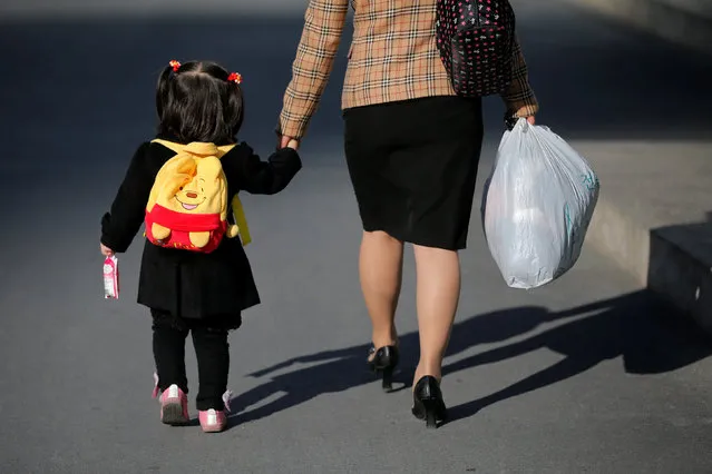 A woman and a child hold hands as they walk at newly built Mirae Scientists Street in central Pyongyang, North Korea May 7, 2016. (Photo by Damir Sagolj/Reuters)