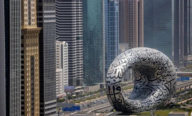 This picture taken on June 30, 2021 shows a view of the Museum of the Future, currently under construction, and skyscrapers along the Sheikh Zayed Road in the gulf emirate of Dubai. (Photo by Karim Sahib/AFP Photo)