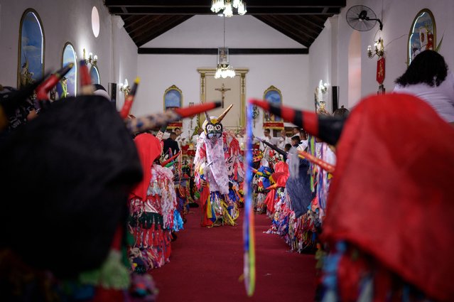 People dressed as a Dancing Devils perform during the Catholic Corpus Christi celebrations at the main church in Tarma, Vargas State, Venezuela on May 30, 2024. The Venezuelan Dancing Devils of Corpus Christi were recognized by UNESCO as Intangible Cultural Heritage in 2012. (Photo by Gabriela Oraa/AFP Photo)
