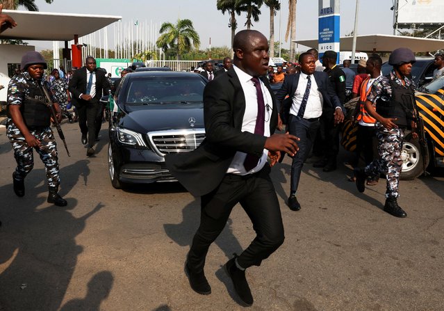 Police and security officials runs with a motorcade of Nigeria's newly declared president Bola Tinubu , in Abuja, Nigeria on March 1, 2023. (Photo by Esa Alexander/Reuters)