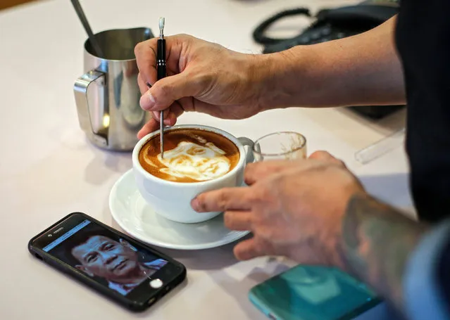 Filipino graphic artist and barista Zach Yonzon, applies finishing touches to the face of Philippine President-elect Rodrigo Duterte on a coffee latte called 'Latte Duterte' inside his cafe and cake studio in Quezon city, northeast of Manila, Philippines, 14 May 2016. Yonzon, admittedly said he did not vote for Duterte, but for Senator Mirriam Santiago. Yonzon draws different faces on top of a coffee lattes upon costumers’ requests. Duterte, the presumptive President-elect will make his first public appearance on 16 May, his spokesperson said. (Photo by Mark R. Cristino/EPA)