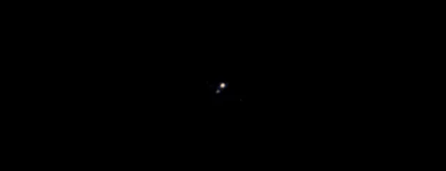 Pluto and its largest moon, Charon, taken by the Ralph color imager aboard NASA's New Horizons spacecraft, April 9, 2015. It is the first color image ever made of the Pluto system by a spacecraft on approach, according to NASA. The image was made from a distance of about 71 million miles. (Photo by Reuters/NASA/Johns Hopkins University Applied Physics Laboratory/Southwest Research Institute)