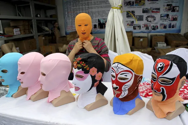 Zhang Shifan tries on a face-kini mask as she demonstrates her products at an exhibition in Qingdao, Shandong province, China, May 22, 2015. (Photo by Reuters/Stringer)