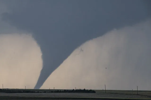 A tornado is seen South of Dodge City, Kansas moving North on May 24, 2016 in Dodge City, Kansas. About 30 tornadoes were reported on Tuesday in five different states from Michigan to Texas. Damage to homes and property was also reported in Ford County, Kansas. (Photo by Brian Davidson/Getty Images)