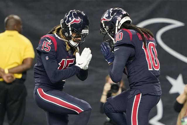 Houston Texans wide receiver DeAndre Hopkins (10) celebrates his touchdown catch against the Indianapolis Colts with teammate Will Fuller (15) during the first half of an NFL football game Thursday, November 21, 2019, in Houston. (Photo by David J. Phillip/AP Photo)