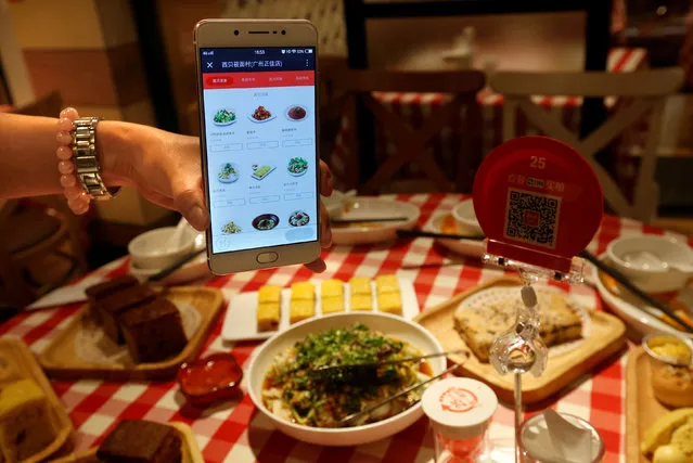 A smartphone using WeChat Pay to take order is demonstrated inside a restaurant in Guangzhou, China May 9, 2017. Picture taken May 9, 2017. (Photo by Bobby Yip/Reuters)
