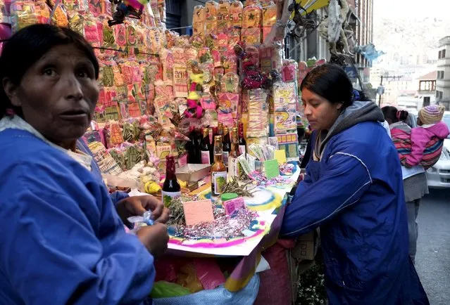 Aymara women sell offerings pieces at the witch doctor's street in La Paz, Boliva July 31, 2015. (Photo by David Mercado/Reuters)