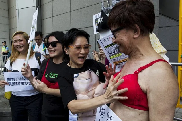 A protester (R) wears a bra during a demonstration in support of Hong Kong female protester Ng Lai-ying, outside the police headquarters in Hong Kong, China August 2, 2015. (Photo by Tyrone Siu/Reuters)