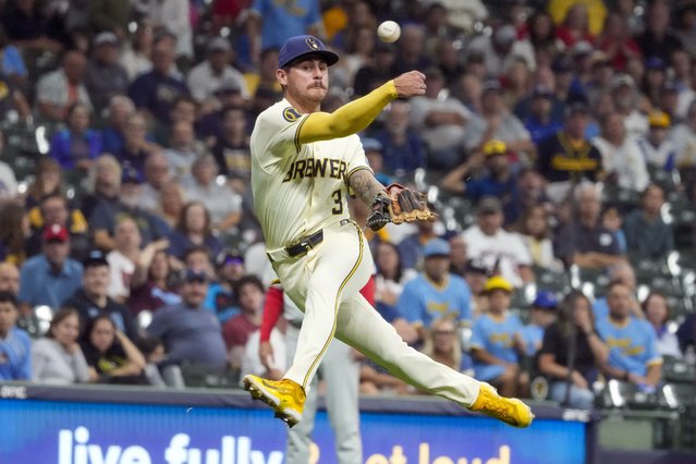 Milwaukee Brewers' Joey Ortiz tries to make a play on a ball hit by Philadelphia Phillies' Kyle Schwarber during the sixth inning of a baseball game Tuesday, September 17, 2024, in Milwaukee. (Photo by Morry Gash/AP Photo)