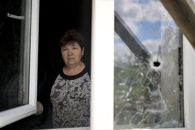 Nataliia Fedorova poses for a picture at her home ruined by attacks in Irpin, on the outskirts of Kyiv, Ukraine, Thursday, May 26, 2022. (Photo by Natacha Pisarenko/AP Photo)