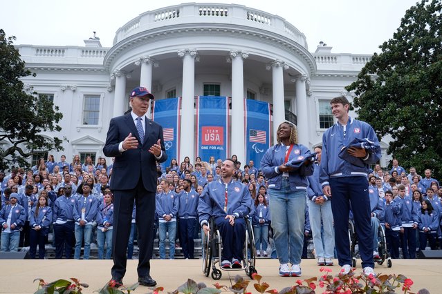 President Joe Biden, from left, speaks as Paralympic wheelchair basketball player Steve Serio, Paralympic sitting volleyball player Nicky Nieves, and Olympic rower Nick Mead, listen during an event celebrating the 2024 U.S. Olympic and Paralympic teams on the South Lawn of the White House in Washington, Monday, September 30, 2024. (Photo by Susan Walsh/AP Photo)