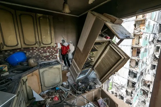 Local resident collects unbroken items at his apartment inside a residential building destroyed by russian army airstrike in the Borodianka town, Kyiv area, Ukraine, June 09, 2022 (Photo by Maxym Marusenko/NurPhoto via Getty Images)