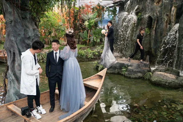 This picture taken on June 4, 2019 shows couples taking part in their pre-wedding photo shoots in the Love Story in Rome Studio in Beijing. Increasingly elaborate pre-wedding photos are a booming industry in China, as young couples spend time and cash lining up glamorous photo shoots to display on their big day. (Photo by Fred Dufour/AFP Photo)