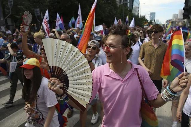 People take part in the “Warsaw and Kyiv Pride” marching for freedom in Warsaw, Poland, Saturday, June 25, 2022. Due to Russia's full-scale war against Ukraine the 10th anniversary of the equality march in Kyiv can't take place in the usual format in the Ukrainian capital. The event joined Warsaw's yearly equality parade, the largest gay pride event in central Europe, using it as a platform to keep international attention focused on the Ukrainian struggle for freedom. (Photo by Michal Dyjuk/AP Photo)