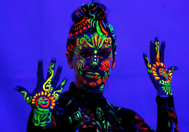 A model displays ultraviolet light paint during the World Bodypainting Festival in Poertschach, Austria, July 1, 2016. (Photo by Heinz-Peter Bader/Reuters)