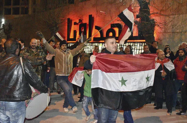 In this photo released by the Syrian official news agency SANA, Syrians celebrate as they hold their national flags in Aleppo province, Syria, Monday, February 17, 2020. On Monday Syria's military announced its troops have regained control of territories in northwestern Syria “in record time”, vowing to continue to chase armed groups “wherever they are”. (Photo by SANA via AP Photo)