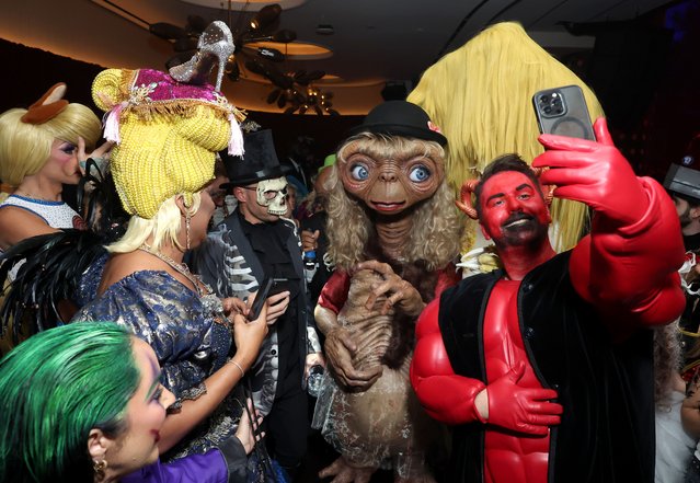 Guests take selfies with Heidi Klum in costume during the Heidi Klum's 23rd Annual Halloween Party presented by Butterfinger, Mattel, and Prime Video at The Venue on Music Row on October 31, 2024 in New York City. (Photo by Mike Coppola/Getty Images for Heidi Klum Halloween)