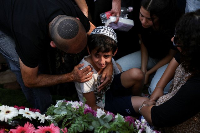 People mourn Israeli Capt. Elad Siman Tov during his funeral in Petah Tikva, Israel, on Friday, October 18, 2024. He was among five Israeli soldiers killed during military operations in southern Lebanon on October 17. Israeli forces have been carrying out ground operations in southern Lebanon as it targets the Iran-backed militant group Hezbollah. (Photo by Violeta Santos Moura/Reuters)