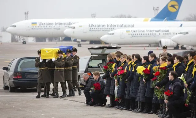 In this photo provided by the Ukrainian Presidential Press Office, honor guard carry a coffin of the one of the eleven Ukrainian victims of the Ukrainian 737-800 plane that crashed on the outskirts of Tehran, at Borispil international airport outside Kyiv, Ukraine, Sunday, January 19, 2020. An Ukrainian passenger jet carrying 176 people has crashed just minutes after taking off from the Iranian capital's main airport on Jan. 8, 2020. (Photo by Ukrainian Presidential Press Office via AP Photo)