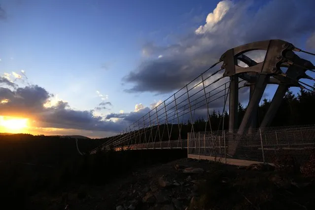 View of a suspension bridge for the pedestrians that is the longest such construction in the world a day before its official opening at a mountain resort in Dolni Morava, Czech Republic, Thursday, May 12, 2022. The 721-meter (2,365 feet) long bridge is built at the altitude of more than 1,100 meters above the sea level. It connects two ridges of the mountains up to 95 meters above a valley between them. (Photo by Petr David Josek/AP Photo)