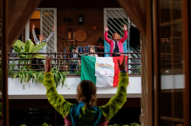 Personal trainer Antonietta Orsini carries out an exercise class for her neighbours from her balcony while Italians cannot leave their homes due to the coronavirus disease (COVID-19) outbreak, in Rome, Italy, March 18, 2020. (Photo by Remo Casilli/Reuters)