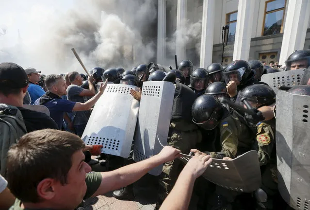 Demonstrators, who are against a constitutional amendment on decentralization, clash with police outside the parliament building in Kiev, Ukraine, August 31, 2015. (Photo by Valentyn Ogirenko/Reuters)