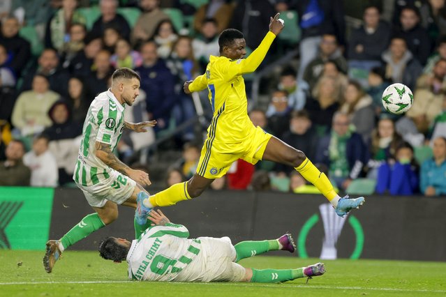 HJK's Hassane Bande jumps over Betis' Chimy Avila next to Aitor Ruibal during the Europa Conference League opening phase soccer match between Real Betis and HJK Helsinki at the Benito Villamarin stadium in Seville, Spain, Thursday, December 19, 2024. (Photo by Toni Rodriguez/AP Photo)