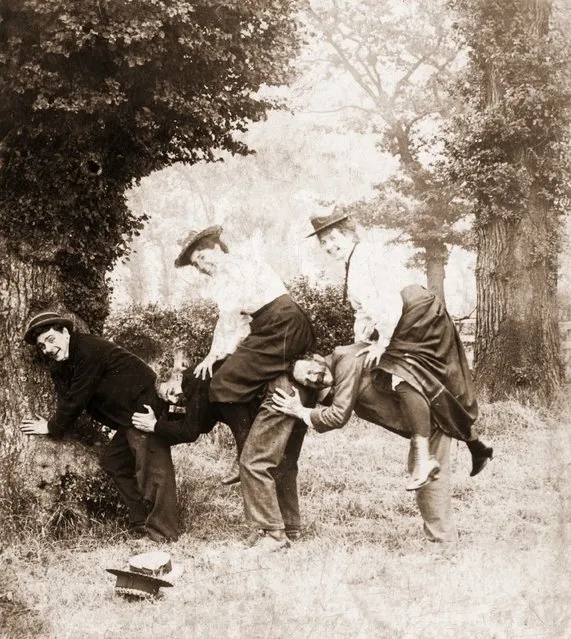 A group of people enjoying themselves with an odd form of leapfrog, 1898. (Photo by Otto Herschan)