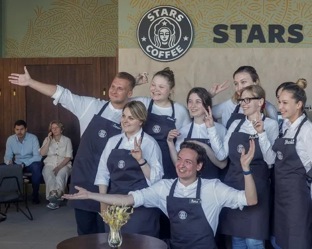 Staff members pose for pictures at the launching of the new coffee shop “Stars Coffee”, which opens following Starbucks Corp company's exit from the Russian market, in Moscow, Russia on August 18, 2022. (Photo by Maxim Shemetov/Reuters)