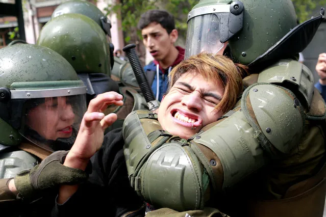 A demonstrator is detained during a rally to request change in the education system in Santiago, Chile September 27, 2017. (Photo by Pablo Sanhueza/Reuters)
