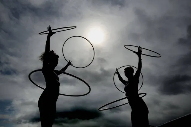 Emerald Lewis and Laura Thomas from the Marawa's Majorettes perform during a cooking demonstration at the Big Feastival held on the farm of Blur bassist Alex James' at Kingham in the Cotswalds, on August 29, 2014. (Photo by Chris Radburn/PA Wire)