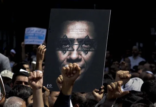 Iranian worshippers chant slogans during a protest after their Friday prayer, as part of widespread anger across the Muslim world about a film ridiculing Islam's Prophet Muhammad on September 14, 2012. (Photo by Vahid Salemi/Associated Press)