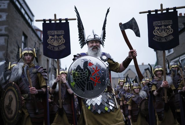 The leader of the march known as The Guizer Jarl leads members of the Up Helly Aa festival’s ‘Jarl Squad’ in the morning parade in Lerwick, Shetland Islands, Britain, 28 January 2025. Up Helly Aa festival dates back to the 1880s and celebrates Viking culture and heritage of the Shetland Islands. The event involves over one thousand torches used in processions by squads of costumed participants, known as guizers, who burn a Viking galley later in the night. (Photo by Tolga Akmen/EPA)