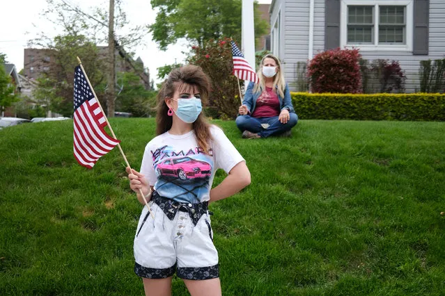 People wear face masks while participating in the annual Memorial Day Parade on May 25, 2020 in the Staten Island borough of New York City. Dozens of cars and nearly 100 members of the patriotic motorcycle group Rolling Thunder joined the event. This year’s parade was diminished in size and in person-to-person contact due to the coronavirus outbreak. Across the country, events honoring the nation’s veterans have been cancelled or scaled back as America continues to experience high numbers of deaths and new cases of COVID-19. (Photo by Spencer Platt/Getty Images)