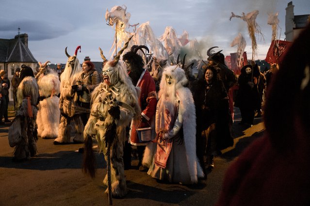 Participants parade through the streets during the annual Whitby Krampus run on December 02, 2023 in Whitby, England. The Whitby Krampus Run is a costumed street parade bringing the Krampus to life. Led by St Nicholas, the Krampus, a horned beast who traditionally carries sticks to beat naughty children, follow behind marching to the beat of drums. (Photo by Ian Forsyth/Getty Images)