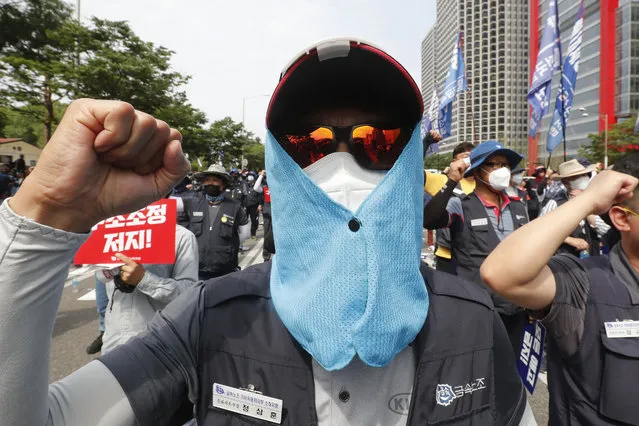 A worker wearing a face mask to help protect against the spread of the new coronavirus shouts slogans during a rally against the government's labor policy in Seoul, South Korea, Wednesday, June 10, 2020. (Photo by Ahn Young-joon/AP Photo)