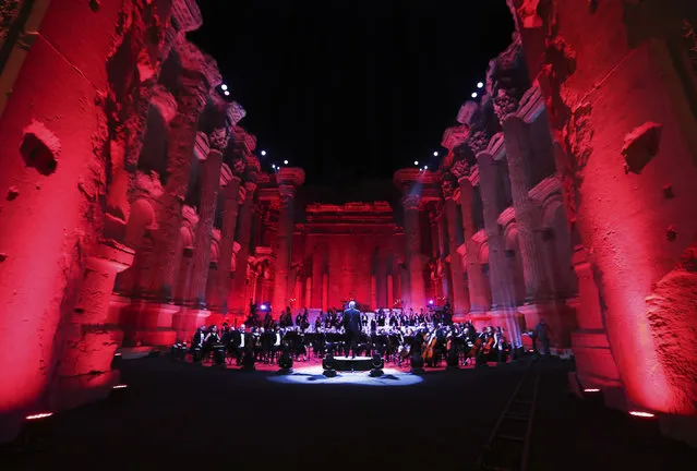 Musicians from the Lebanese Philharmonic Orchestra perform during a concert in the ancient northeastern city of Baalbek, Lebanon, Sunday, July 5, 2020. Dubbed “an act of cultural resilience”, the concert aims to send a message of unity and hope to the world amid the coronavirus pandemic and an unprecedented economic and financial crisis in Lebanon. For the first time since the Baalbek International Festival was launched in 1956, this year's concert is being held without an audience, in line with strict COVID-19 guidelines. Instead, it is being broadcast live on local and regional TV stations and live-streamed on social media platform. (Photo by Bilal Hussein/AP Photo)