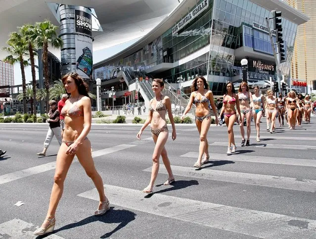 Women in bikinis march across the Las Vegas Strip as they help the Las Vegas Convention & Visitors Authority earn a Guinness World Record for staging the world's largest bikini parade with 281 participants May 14, 2009 in Las Vegas, Nevada. (Photo by Ethan Miller/Visitlasvegas.com)