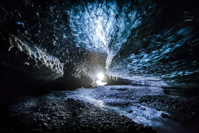 These frozen caves seem almost otherworldly as they daylight illuminates them. Matej Kriz’s shots reveal the beauty of the brilliant caves, but he’s also very aware of how deadly they can be. The photographer captured the amazing shots in the Vatnajokull National Park on the Breidamerkurjokull glacier tongue. Matej said: “One of the ice caves has been well known for few years already, but new ones appeared on east side of the glacier tongue this year. I live in the area for almost one year and exploring is part of my job – since I am working in the Jokulsarlon Glacier Lagoon, we were able to spot them from the boats in the end of the summer. Since my job involves cooperating with local companies, I have good relationships with them, and they told me about caves hidden from tourists, chichis the crystal blue one. It is always dangerous in these areas, to some of them you can get on the boat and then climb on the glacier, or with a super jeep or on your own, but anything can happen at any time of course. There are active volcanoes under the glacier, and earthquakes can break the entrance to the cave … or you can encounter an Icelandic troll! The caves change every second thanks to the light, but it is just appearance during the days. The biggest problem is the warm weather or rain because ice caves are created by streams of water – it is basically a glacier’s waste pipe. Iceland is magical country and the ice caves are a fantasy world all by themselves. You can admire the whole thing or focus on details hidden in the ice and find much more”. Here: The ice caves, taken in the Vatnajokull National Park in Iceland, on November 11, 2017. (Photo by Matej Kriz/Caters News Agency)