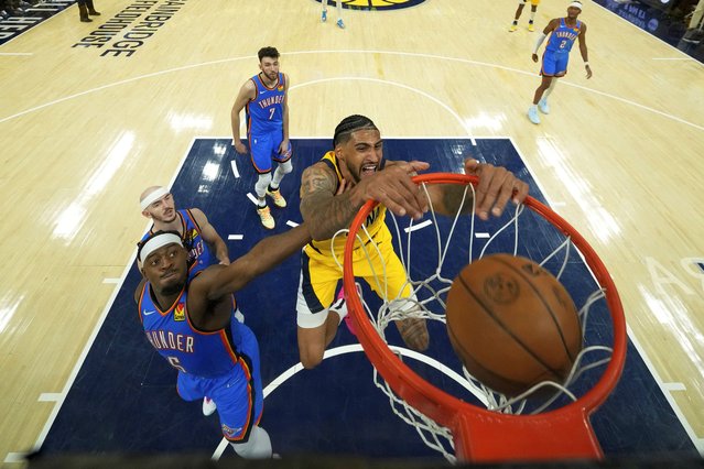 Indiana Pacers forward Obi Toppin (1) dunks over Oklahoma City Thunder guard Luguentz Dort (5) during the second half of Game 3 of the NBA Finals basketball series, Wednesday, June 11, 2025, in Indianapolis. (Photo by Abbie Parr/AP Photo)