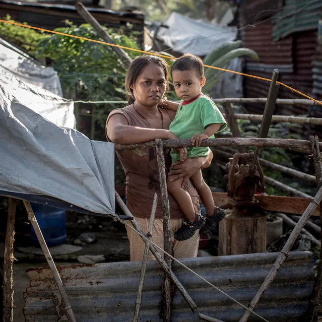 Typhoon Haiyan survivor Merluna Lamban stands amongst the ruins of her home on November 6, 2014 in San Antonio, Samar, Philippines. Merluna has used what materials she could find to build a temporary house on the original location but does not have the funds to rebuild permanently. (Photo by Chris McGrath/Getty Images)