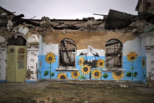 A painting decorates the façade of a house damaged during the Russian occupation in Bucha, near Kyiv, Ukraine, Friday, February 17, 2023. (Photo by Emilio Morenatti/AP Photo)
