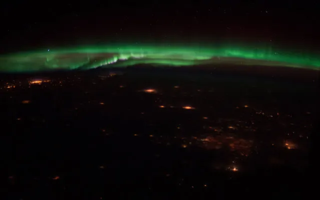 One of the Expedition 34 crew members captured this night panorama featuring a display of Northern Lights, and scattered lights in the more highly populated areas in the state of Colorado and possibly the states north of it, on February 10. 2013. (Photo by NASA/The Atlantic)